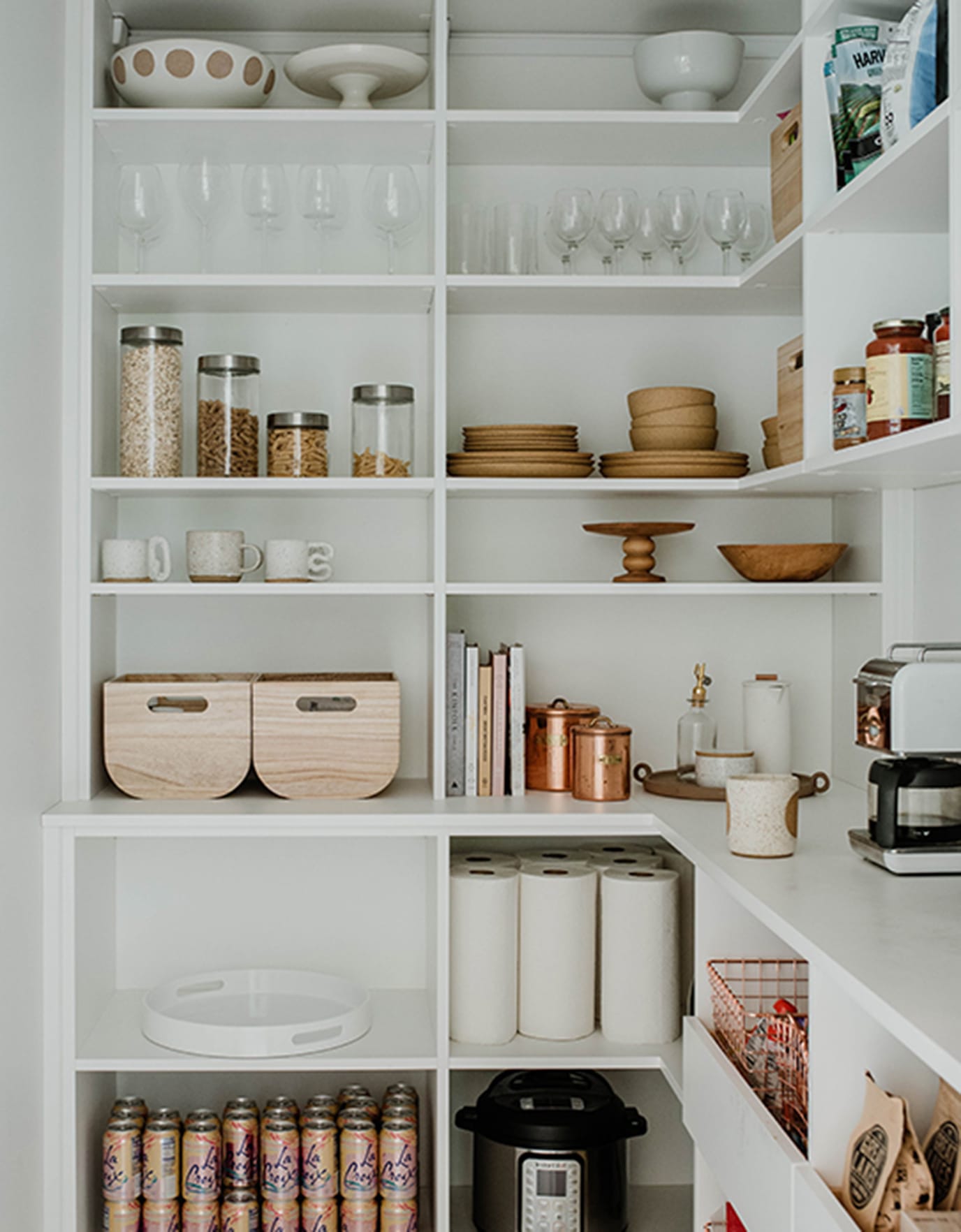 Sarah Sherman gets a customized kitchen pantry with open shelving and corner wrap storage in white finish by California Closets