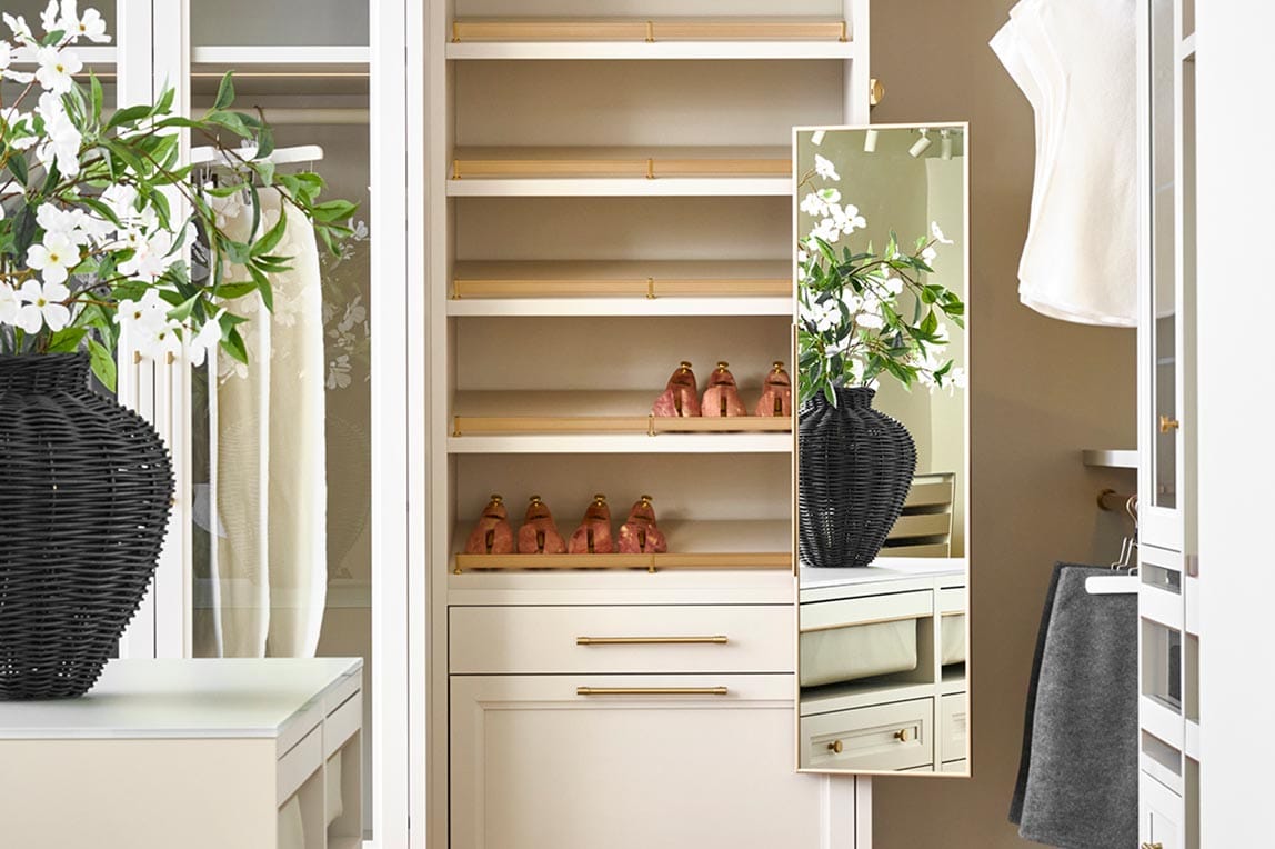 Small walk in closet with custom organization with open shelves by California Closets