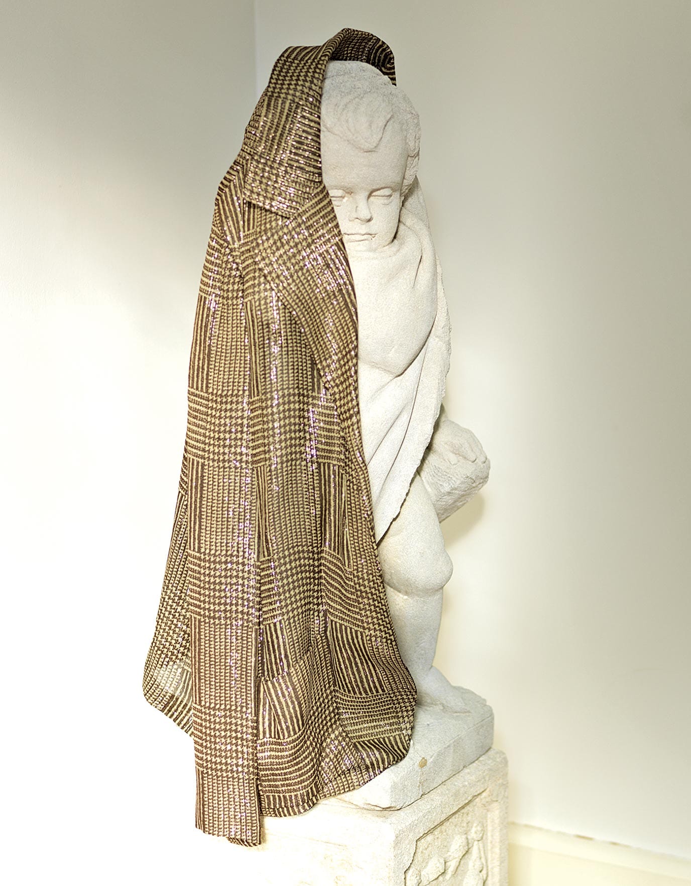 Gold jacket belonged to Ellie Montgomery draped over a statue in Ideas of Order Magazine